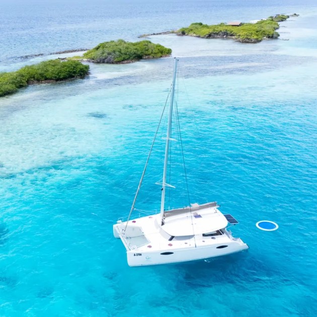 AWA, a 44ft Fountaine Pajot catamaran, anchored on turquoise water off Aruba