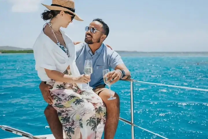 Guests toasting with sparkling wine on the deck of a private charter in Aruba